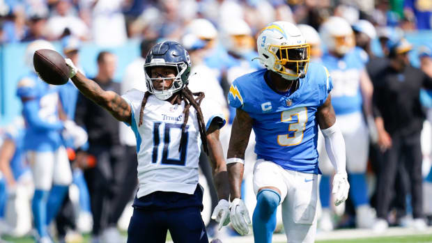 Titans wide receiver DeAndre Hopkins (10) celebrates a catch in the fourth quarter after being stopped by Los Angeles Chargers safety Derwin James Jr. (3) at Nissan Stadium.